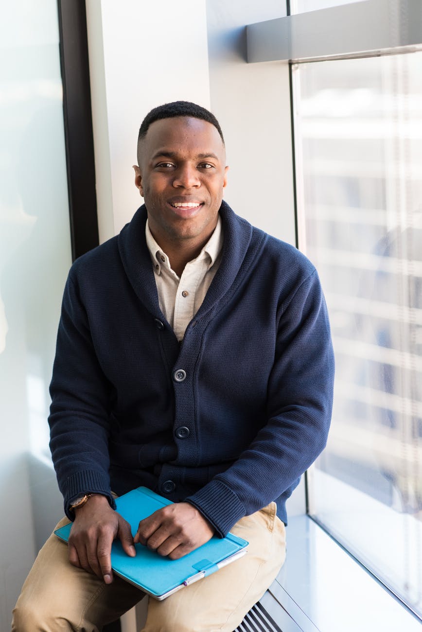 man wearing blue button up sweater