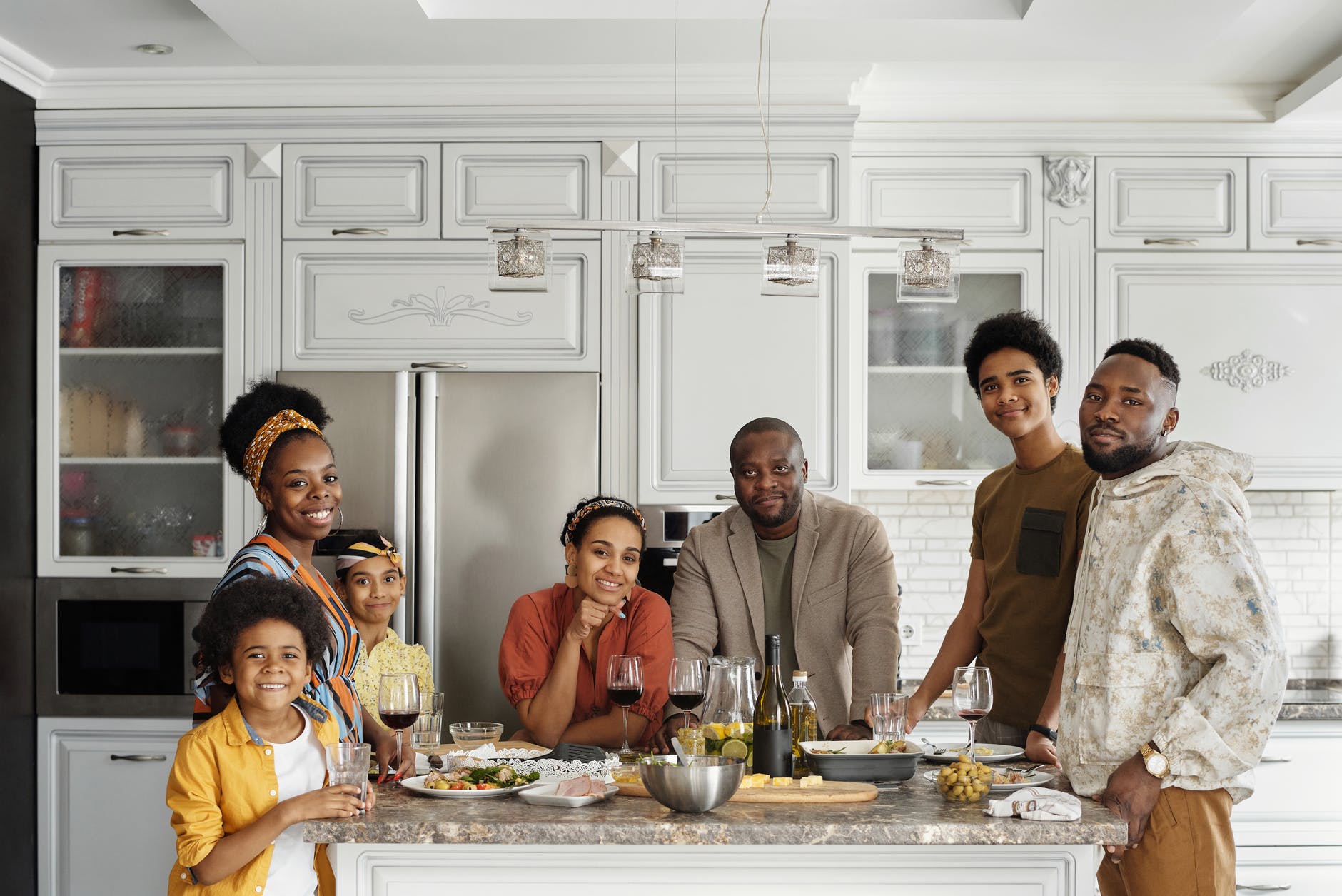 family posing for a photo in the kitchen smart money bro