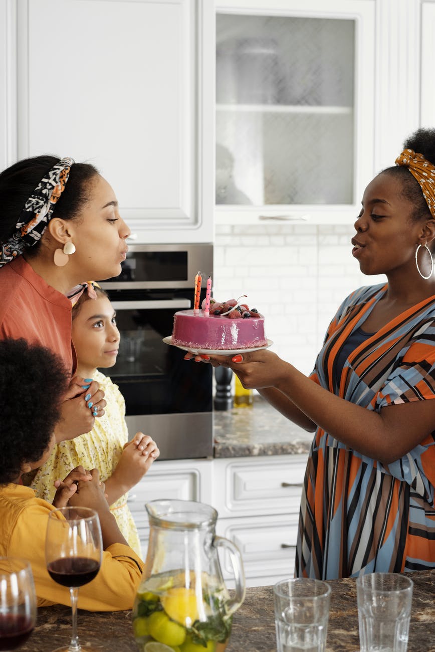 woman blowing birthday candles