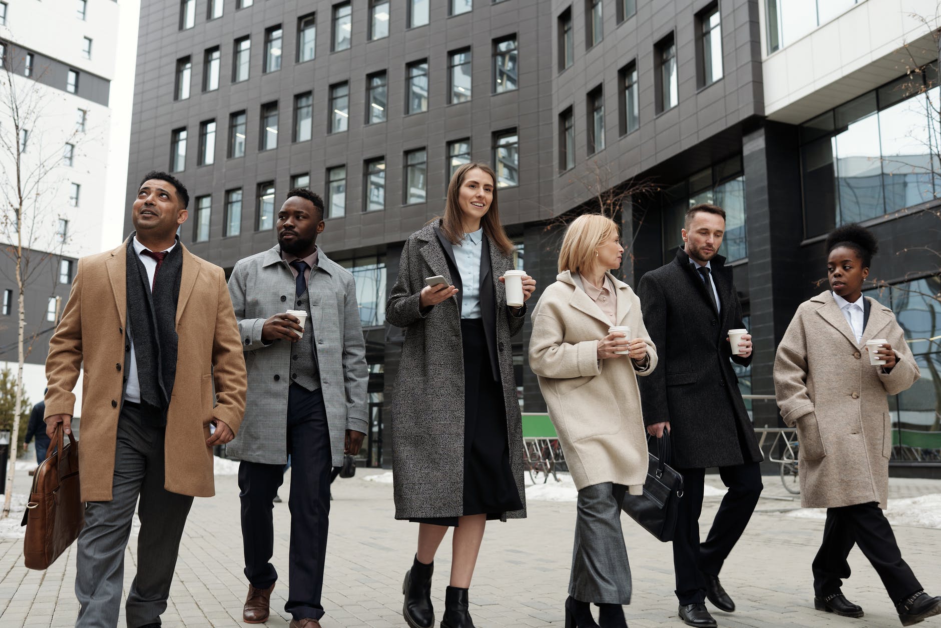 coworkers taking a coffee break and walking. smart money bro