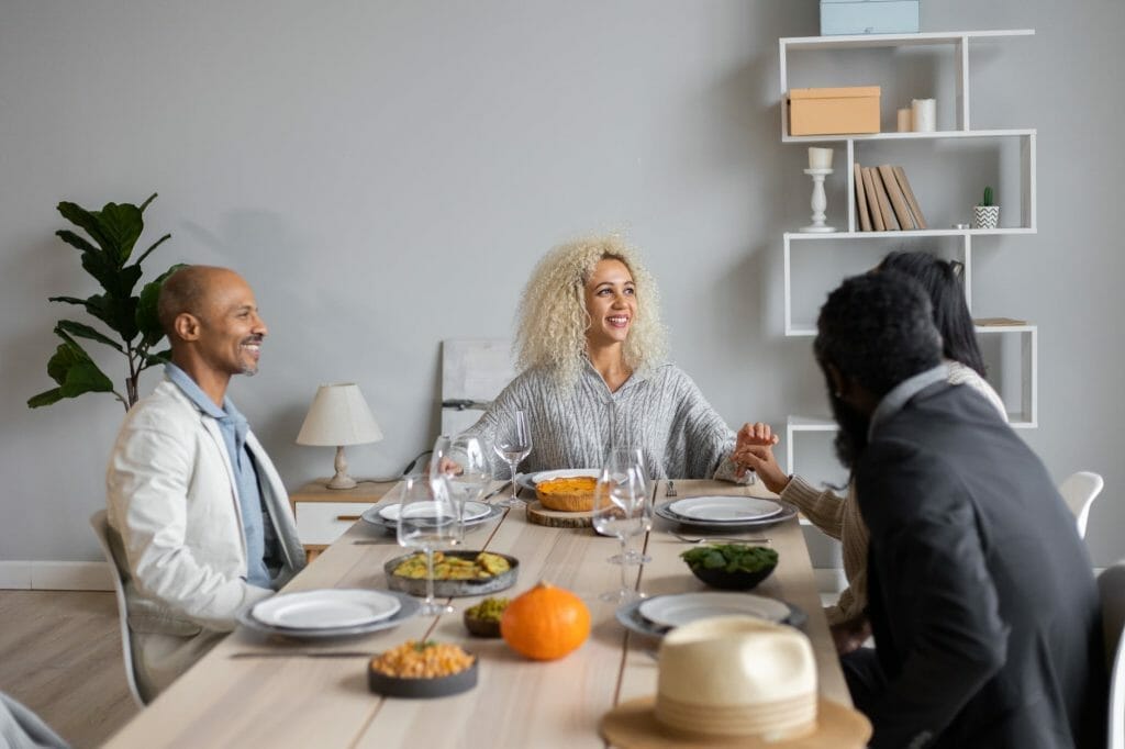 cheerful people having dinner together