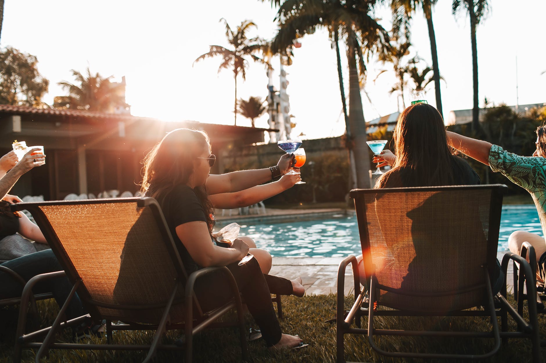 friends clinking glasses while having rest