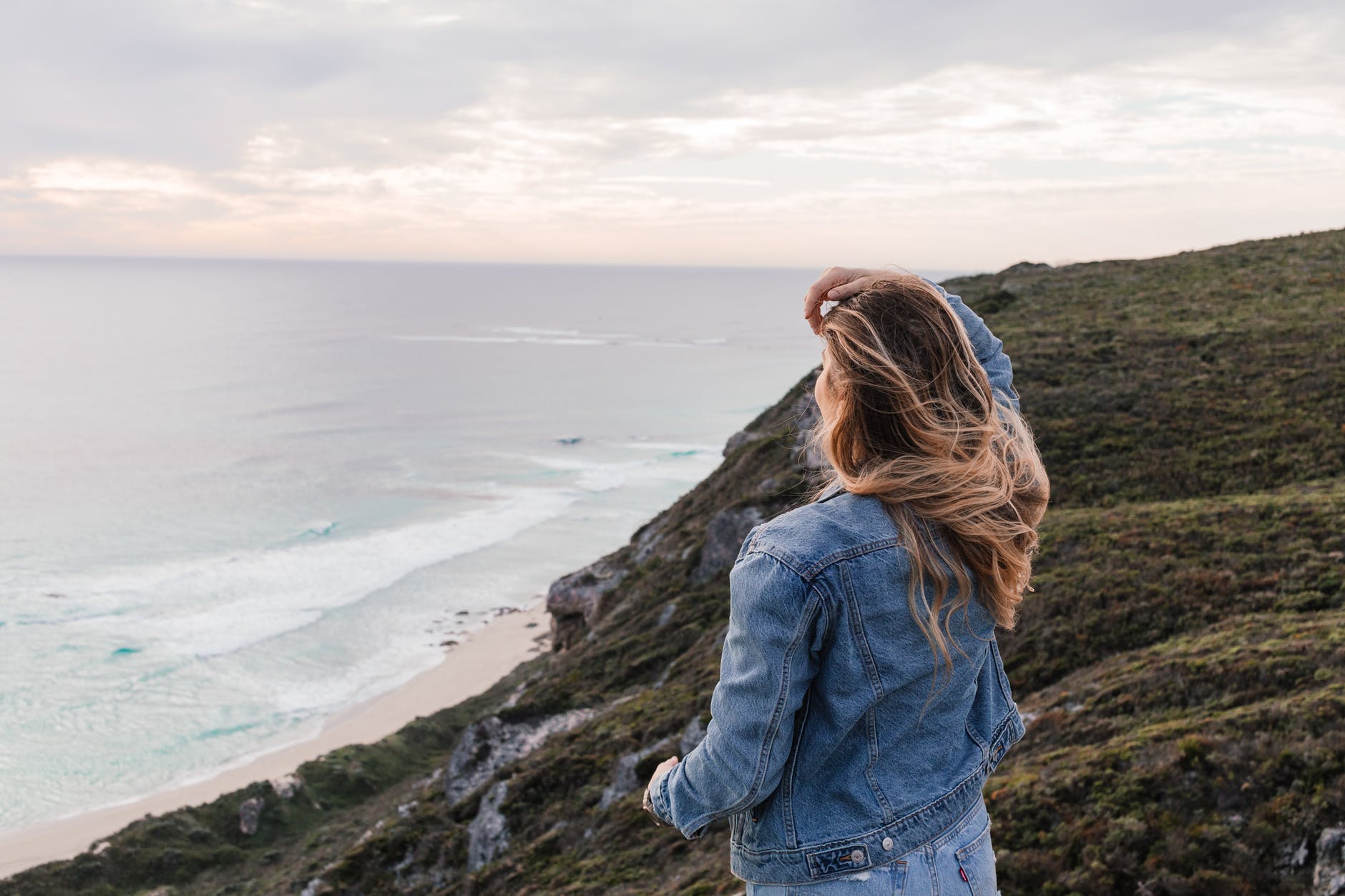 anonymous woman standing on cliff