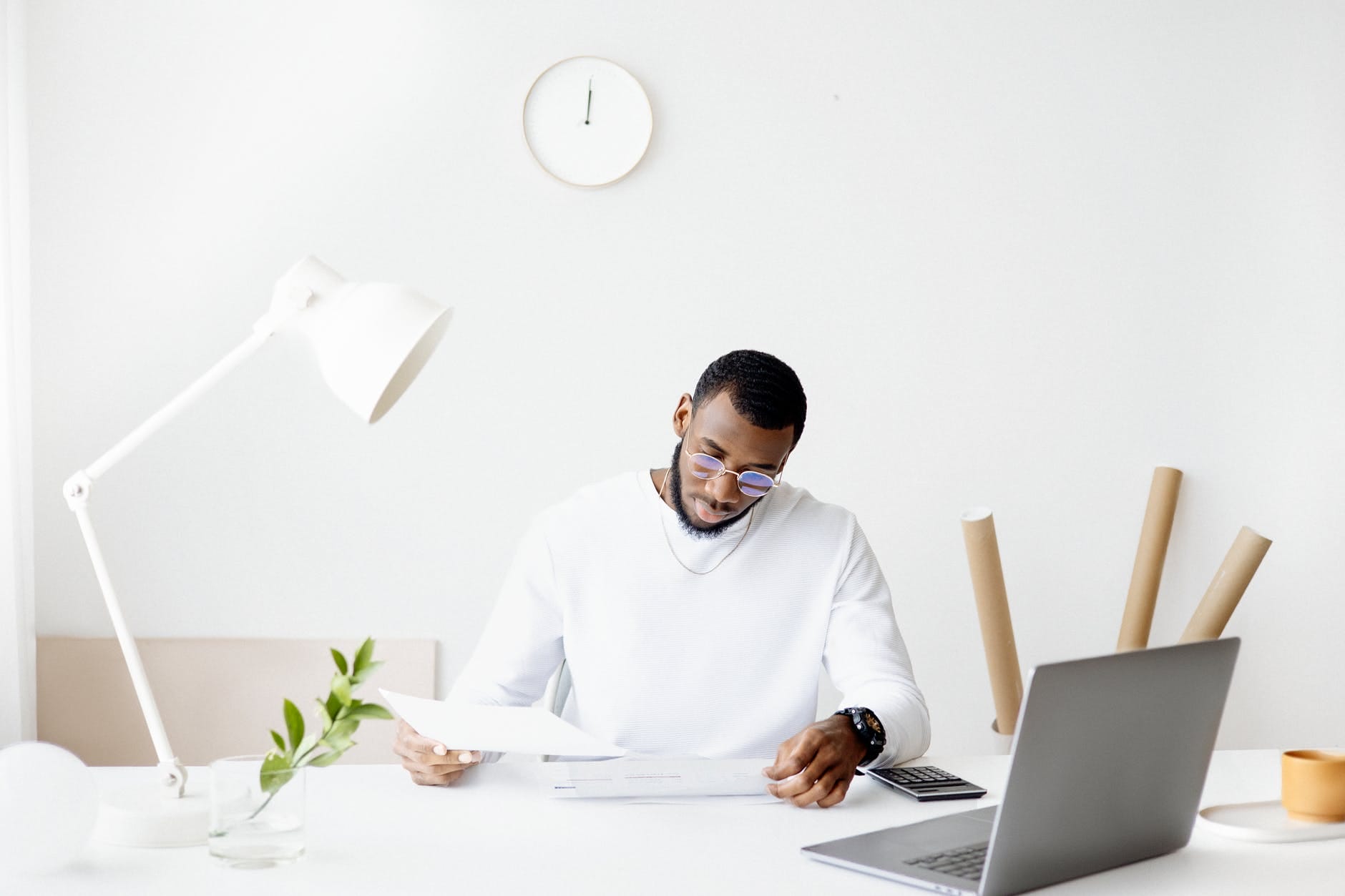 person smartphone desk laptop thinking. Smart Money Bro.