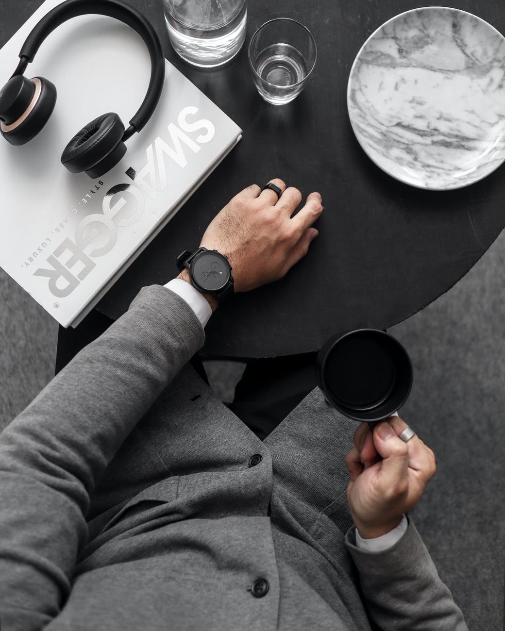 man holding black ceramic mug smart money bro