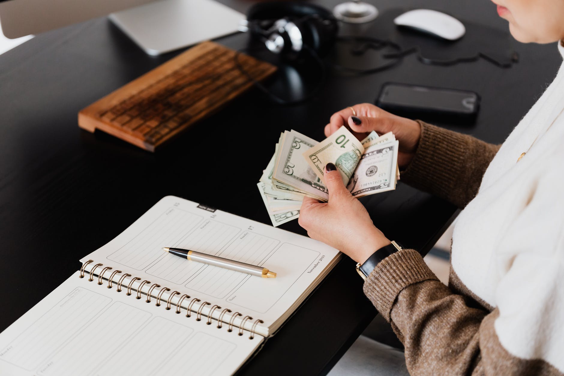 crop entrepreneur counting money in office, smart money bro