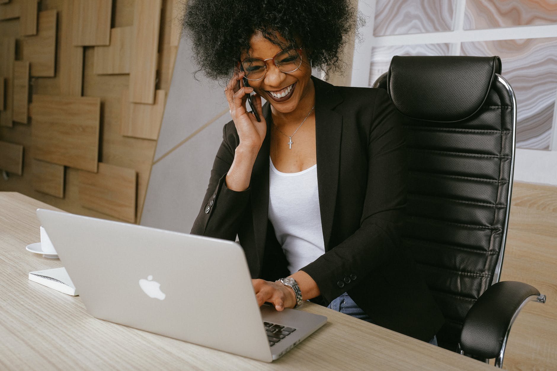 woman in black blazer sitting on black office chair, smart money bro