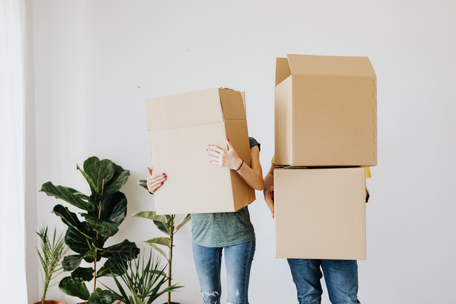 couple carrying cardboard boxes in living room, do you have to like your tenants, smart money bro