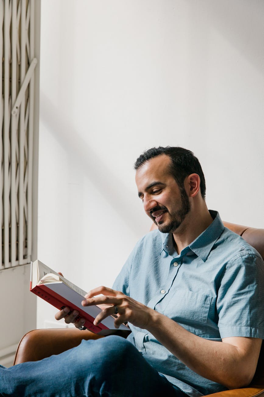 man in blue dress shirt reading a book, who wants to be a millionaire, smart money bro