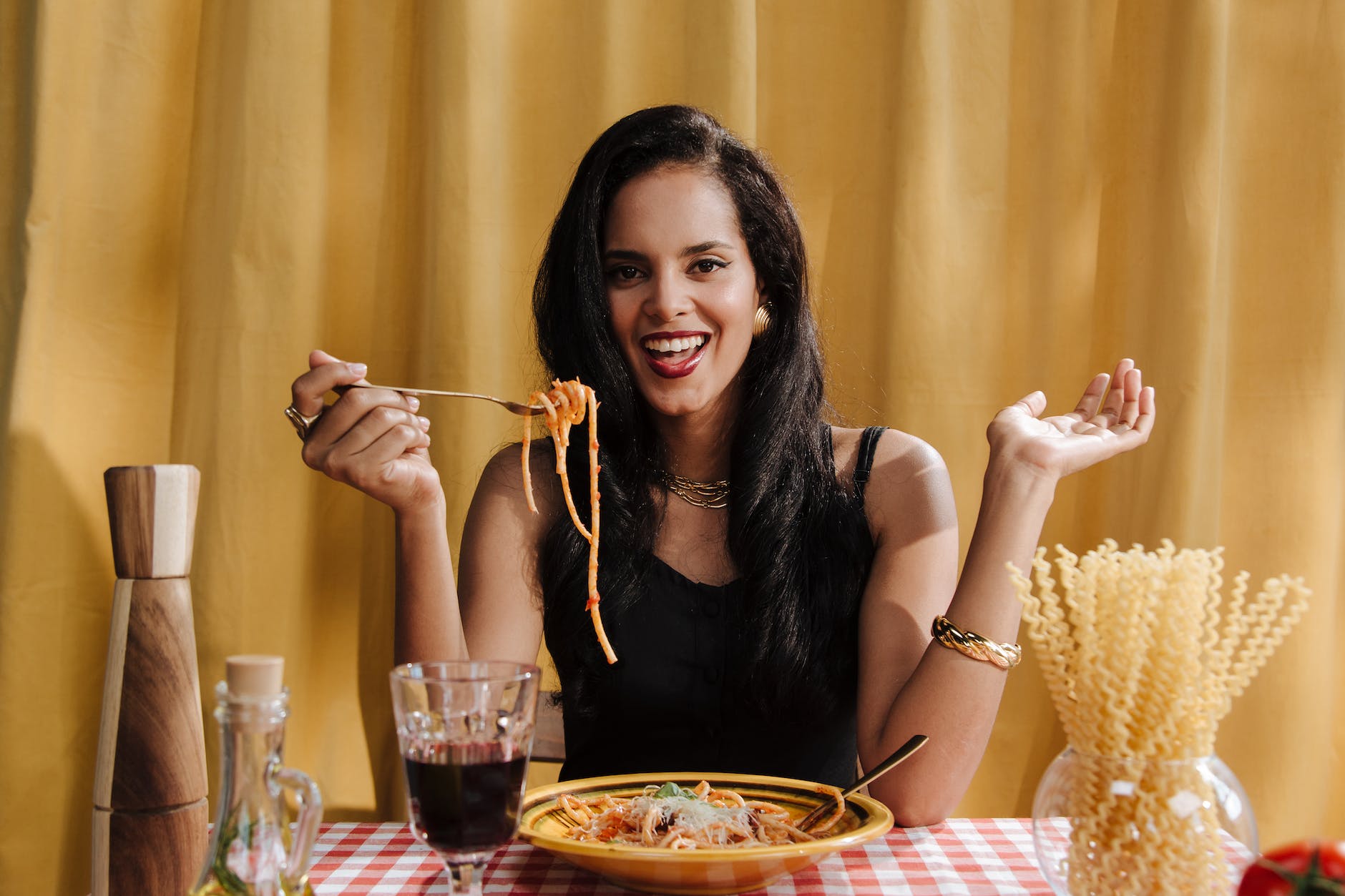smiling woman eating pasta